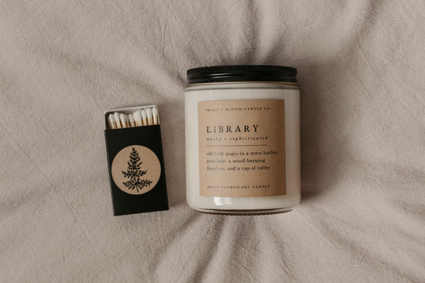 This gorgeous gift set from Grace and Bloom Co, which includes a custom "Will you be my ..." card that doubles as a bookmark, a black matchbox with white-tipped matches, and an 8 oz literary-themed scented soy candle - the perfect way to express your appreciation with a delightfully bookish and memorable bridesmaid proposal.