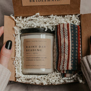 Surprise your bridesmaids with a thoughtful and aesthetic dark academia-themed bridesmaid proposal gift box! They'll be all ready for a cozy evening of reading with this gorgeous set, which includes a custom "Will you be my ..." card that doubles as a bookmark, a pair of comfy striped socks, and a literary-themed scented soy candle - the perfect way to express your appreciation with a delightfully bookish and memorable bridesmaid proposal.