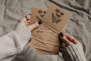 each gift comes with a card in a vintage style that asks the question, "Will you be my bridesmaid?"  You can ask any member of your bridal party to be a part of your wedding! Just choose the title you need from the dropdown menu! The photo shows hands with black nail polish holding an assortment of these cards with various bridal party titles on them.